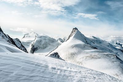 Scenic view of snowcapped mountains against sky