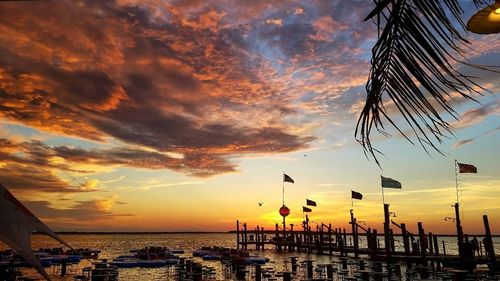 Silhouette beach against sky during sunset