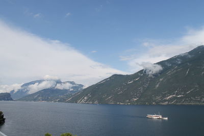 Scenic view of sea and mountains against sky