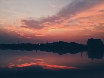 Scenic view of lake against romantic sky at sunset