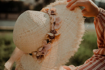 Close-up of woman holding hat