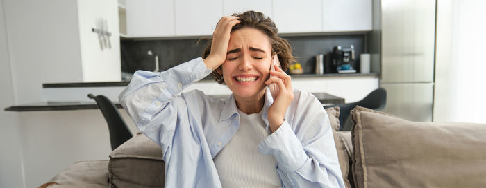 Portrait of young woman using laptop at home