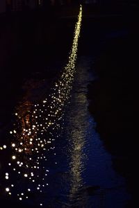 Illuminated firework display at night