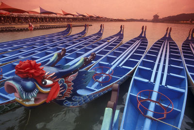 Multi colored boats moored in sea