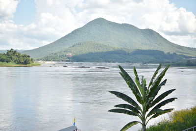 Scenic view of sea and mountains against sky