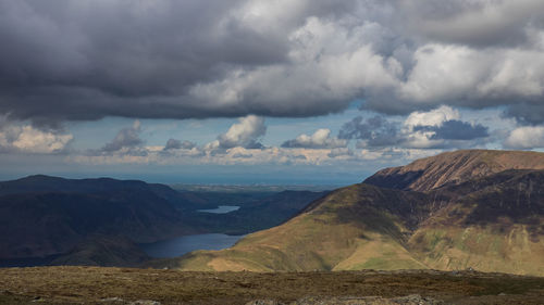 Scenic view of mountains against cloudy sky