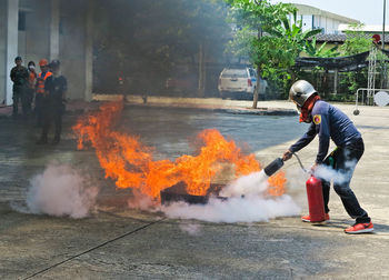 Firefighter extinguishing fire