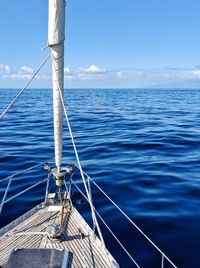 Sailboat sailing on sea against sky