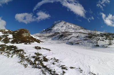 Scenic view of snowcapped mountains against sky