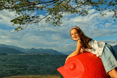 Portrait of smiling woman against mountains