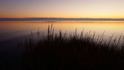 Scenic view of lake against sky during sunset