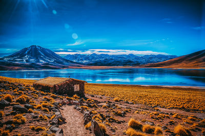 Scenic view of snowcapped mountains against blue sky