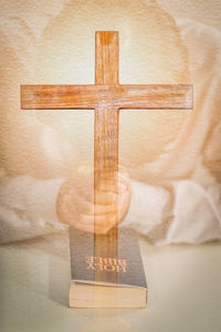 Close-up of cross on table at temple