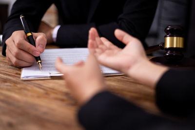Midsection of woman holding paper with text