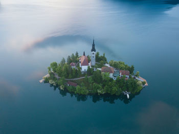 Scenic view of lake and buildings against sky