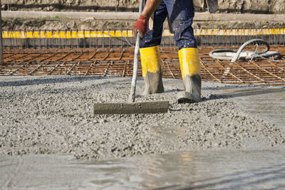 Low section of man working at construction site