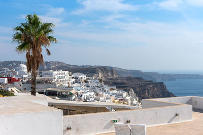 View of buildings in sea against cloudy sky