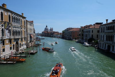 High angle view of boats on river in city