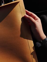 Cropped hand of person holding paper