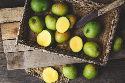 High angle view of fruits in basket on table