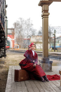 Portrait of young woman sitting on chair