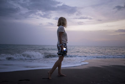 Full length of woman standing on beach