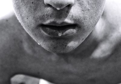 Close-up water drop on lips of teenage boy