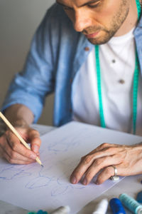 Midsection of man working at table