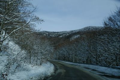 Snow covered road against sky