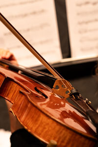 Midsection of person playing violin during orchestra