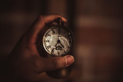 Close-up of hand holding stopwatch