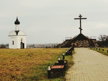 Cross in temple against sky