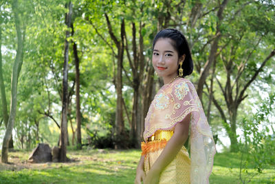 Girl in traditional clothing standing at park