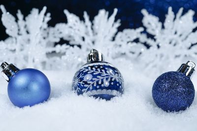 Close-up of christmas decorations on snow