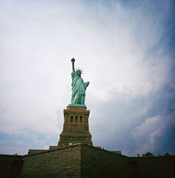 Low angle view of statue against cloudy sky