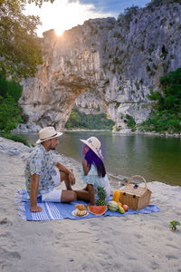 People sitting on shore at beach