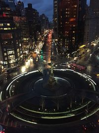 Aerial view of city lit up at night