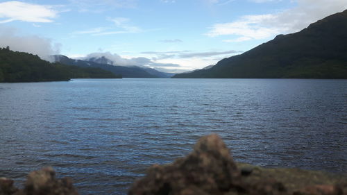 Scenic view of lake against cloudy sky