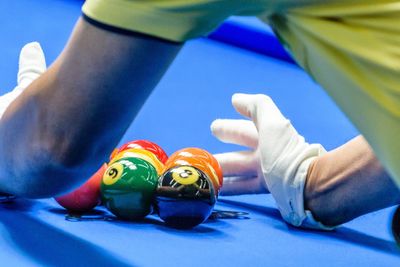 Cropped hands arranging balls on pool table