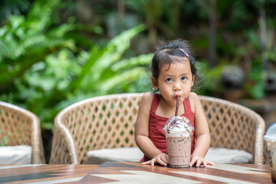 Portrait of a girl sitting on table