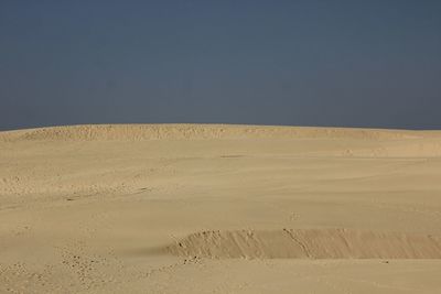 Scenic view of desert against clear sky