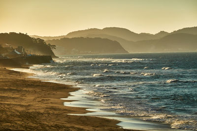 Scenic view of sea against clear sky during sunrise