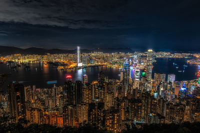 Illuminated cityscape against sky at night