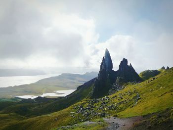 Scenic view of landscape against cloudy sky