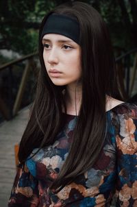 Thoughtful young woman by footbridge