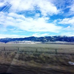 Scenic view of mountains against cloudy sky