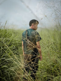 Side view of man standing on field