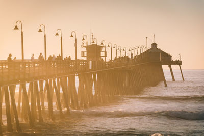 Pier on sea against clear sky