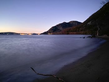 Scenic view of sea against clear sky during sunset