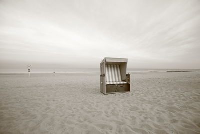 Lifeguard hut on beach against sky